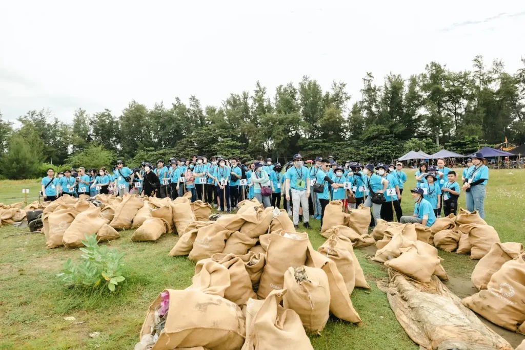 Volunteers pose with bags of trash picked up