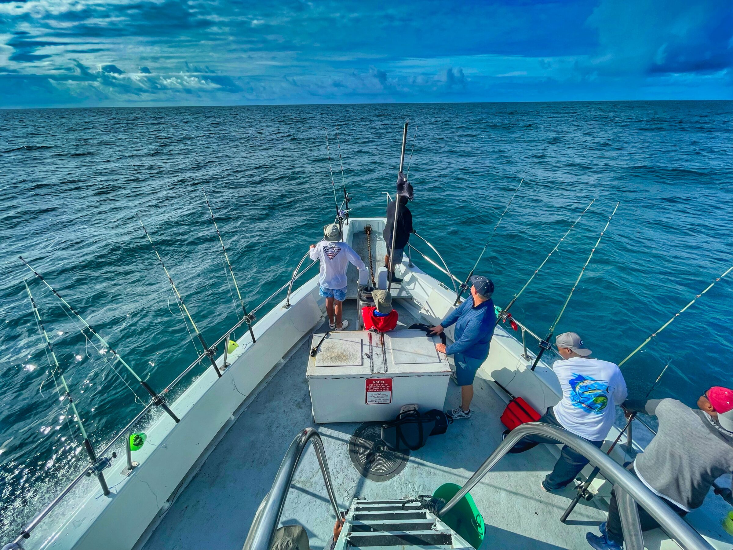 people riding on white boat during daytime