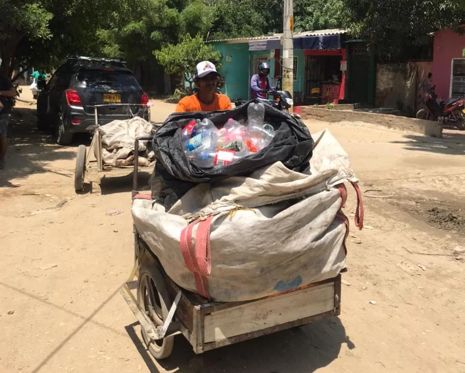 Waste collector walks on the street